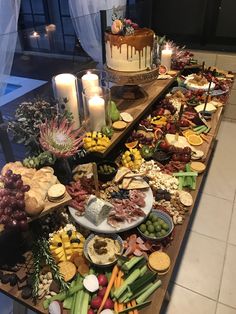 a buffet table filled with different types of food and candles on top of the tables