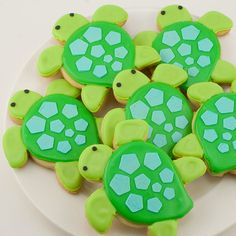 decorated cookies in the shape of turtles on a plate