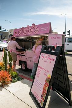 a food truck is parked on the side of the road