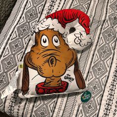 a pillow with a cartoon character wearing a santa claus hat on it's head