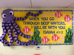 a bulletin board with an octopus on it in a school hallway that says, when you go through deep waters i will be with you