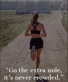 a woman running down a dirt road with the quote go the extra mile, it's never crowded