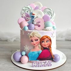 a frozen princess birthday cake with balloons and decorations