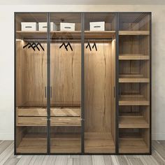 an empty walk in closet with wooden shelves and black glass doors that are open to the side