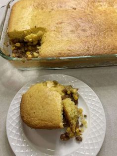 a piece of cake sitting on top of a white plate next to a casserole dish