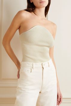 Find KHAITE Jericho Strapless Ribbed-knit Top on Editorialist. Khaite's 'Jericho' top is made from a thick ribbed-knit that provides structure without the need for boning or underwire. Designed for a figure-hugging fit, it has a strapless, convex neckline and contouring darts along the cups. Style yours with leather pants or use it to underpin tailoring. Fitted Off White Knit Top, Fitted Off-white Knit Top, Beige Stretch Strapless Top, Chic Strapless Knit Top, Chic Beige Strapless Top, Fitted Fine Knit Cream Top, Khaite Top, Black Mesh Top, Ribbed Knit Top