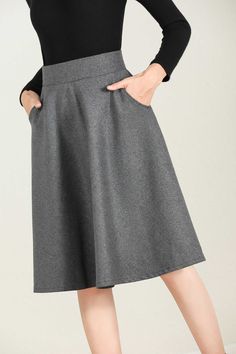 "This winter wool skirt is a classic piece of tailoring that will see you through rain or shine. It is cut with a flattering flared skirt to give you a wonderful shape. The winter skirt is perfect classic styling and ends at the ankle. This is a versatile skirt that you'll wear again and again. DETAILS: * 30% wool, 30% fiber, 40% polyester * fully satiny liner * Two side pockets * Right zip closure * A litter Back elastic, comfortable wear * Plus size skirt * Above knee length * Perfect for Wint Winter Full Skirt Bottoms With Pockets, Winter Flared Skirt With Pockets, Solid Color Skirt For Winter Workwear, Elegant Fall Skirt With Pockets, Winter A-line Bottoms With Pockets, Solid Color Winter Workwear Skirt, Gray Lined Skirt For Winter, Winter Workwear Skirt With Pockets, Chic Wool Skirt With Pockets