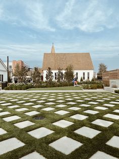 a large yard with grass on the ground and a house in the background that looks like it is made out of bricks