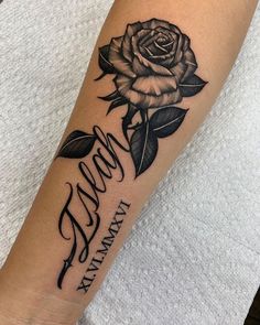 a black and white rose tattoo on the arm with words written in cursive writing