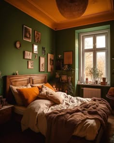 a bedroom with green walls and pictures on the wall