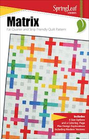 a book cover with an image of a colorful quilt