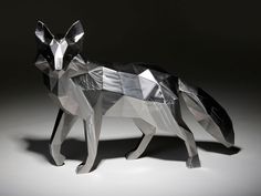 an origami sculpture of a fox on a black background