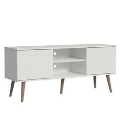 a white tv stand with wooden legs and an open shelf on one side that has two doors