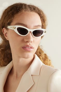 The sleek cat-eye shape of Dior Eyewear's 'CDior B1U' sunglasses give them a glamorous, Old Hollywood feel. Made in Italy from ivory acetate, they have gold-tone hinges that you'll notice are shaped to resemble the brand's initials when viewed from above. White Acetate Cat Eye Sunglasses, Chic White Cat Eye Sunglasses In Acetate, Chic White Evening Sunglasses, Dior Eyewear, Eyewear Womens, Eye Shapes, Designer Sunglasses, Gold Tone Metal, Old Hollywood