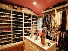 an organized closet with lots of shoes and other items on display in the center area