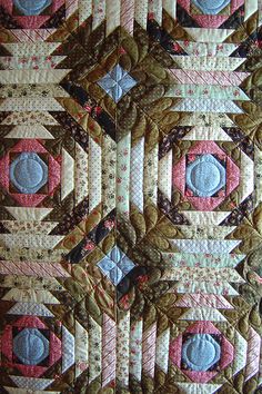 a close up view of a quilted wall hanging