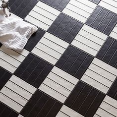 black and white tiled floor with a towel on it