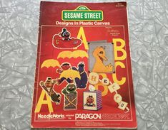 the sesame street design in plastic canvass book is open to show its various designs