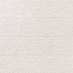 a white brick wall textured with lines