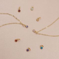 "Our dainty 14kt gold filled birthstone necklace features a tiny cubic zirconia in your choice of colored stone. These dainty birthstone necklaces are the perfect gift for a friend, sister, new mom or just for you! All items come gift boxed in our signature packaging. Ready to gift or treat yourself to a fun un-boxing moment. ♡ DETAILS: - 14kt gold filled chain and charm - won't tarnish or turn, water-proof - choose length at checkout - model wearing this 17\" layered with our satellite choker: Birthstone Necklaces, Gold Birthstone Necklace, Personalized Gold Jewelry, Birthstone Charm Necklace, Deer Jewelry, Mini Gold, Pearl Necklace Earrings, Colored Stone, Travel Jewelry Case