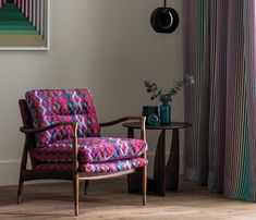 a colorful chair and table in front of a window