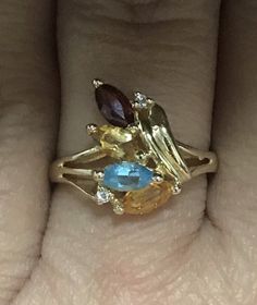 Pretty ESTATE 14K Yellow Gold Marquise Gemstone and Diamond Ring Size 6.25 Very pretty and unique ring! * 2.5 grams * Size 6.25 * 14k Yellow Gold with assorted marquise cut gemstones - blue topaz, citrine and garnet and small round genuine diamond accents! * Shipped in a gift box Please message me with any questions I guarantee item to be exactly as described and pictured. Black Opal Pendant, Black Gift Boxes, Unique Ring, Multi Stone Ring, Opal Pendants, Marquise Cut, Black Opal, Star Pendant, Unique Rings