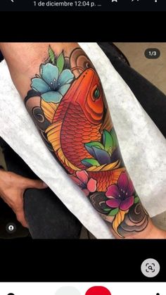 a colorful fish with flowers on it's leg is shown in this tattoo design