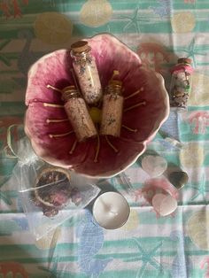 a bowl filled with wine corks sitting on top of a table next to other items