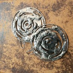 two metal objects sitting on top of a wooden table