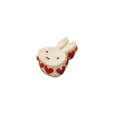 a small white and red rabbit with hearts on it's back