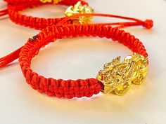 Large Pixiu knotted red bracelet High Quality Gold Plated Pixiu/Red Bracelet Pixiu approximately 1.15 (more than an inch) Adjustable Bracelet Combinations of gold and red are seen on special occasions, accessories etc... and is a winning color combination. Gold plated means that the jewelry is made with a layer of gold on the surface over another type of metal underneath. Jewelry is usually made of a lower karat which contains copper or nickel or silver or other metals, and a lot of gold jewelry Chinese Talisman, Bracelet Combinations, Piyao Bracelet, Wealth Symbol, Pixiu Bracelet, Cat Bracelet, Happy Lunar New Year, Red Bracelet, Lucky Bracelet