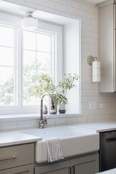 a kitchen sink with a window in the background