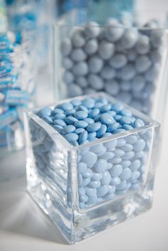 two clear cubes filled with blue and white candies