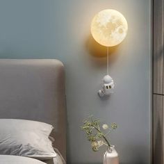 a bedroom with a bed, night light and vase on the nightstand next to it