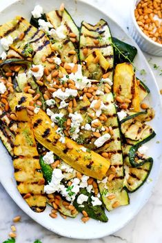 grilled zucchini with chickpeas, pine nuts and feta cheese