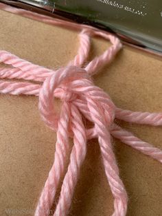 a piece of pink yarn sitting on top of a table