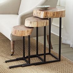 three wooden tables sitting on top of a rug in front of a white couch and chair