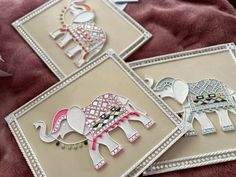 three framed pictures with decorative elephants on them