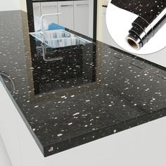 a black counter top with white speckles on it