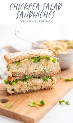 a chicken salad sandwich cut in half on a cutting board