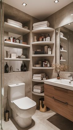 a bathroom with shelving, toilet and sink is shown in this image from the front view