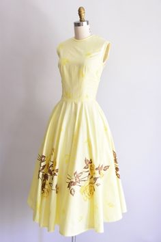 "Vintage 1950s cotton handmade dress. Pale yellow with sizable rose print at border and falling leaves throughout. Scoop collar, sleeveless, and nipped waist. Full skirt. Back and side metal zipper closure. \"American Beauty\" printed on inner seams of dress. State of garment | very good, light overall fading and faint staining on skirt (hard to detect). Measurements ✂--- Best fit | Small Bust | max 35.5\" Shoulders | 15\" Shoulder to waist | 18\" *best fit for someone with a longer torso Sleeve Yellow 1950s Sleeveless Dress, Yellow 1950s Style Sleeveless Dress, Yellow Sleeveless 1950s Dress, Sunshine Dress, Morgan Dress, Peach Dress, Handmade Dress, Beauty Design, Falling Leaves