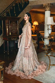 Pakistani Bridal Dress in Embellished Walima Gown Style is an epitome of beauty and elegance. This stunning Pakistani Bridal Gown is adorned with the hand-crafted details of beads, tilla, dabka, naqshi, and Resham, making it your foremost priority for the big day to have a magical look. Pakistani Bridal Gown: Pakistani Bridal Gown in an alluring peachy pink color has the perfect balance of beauty and glamour. This stunning Pakistani Gown is beautifully embellished with the intricate gold and silverwork. Shimmering ornaments, intricate designs, zardosi, motifs, sequins, crystals, and pearls give a glamorous touch to this perfectly stitched Pakistani Wedding Dress. The borders of the Gown are adorned with ruffles, giving a royal touch to this Pakistani Bridal Outfit. Lehenga is prepared on c Bridal Gown Pakistani, Pink Pakistani Bridal Dress, Walima Gown, Pakistani Bridal Gown, Gown Pakistani, Pakistani Gown, Pakistani Bridal Dress, Bridal Dupatta, Asian Bridal Dresses