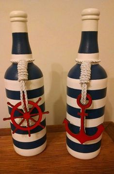 two nautical themed bottles are sitting on a table