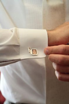 a man wearing a white shirt and cufflinks