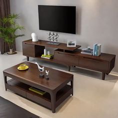 a living room with two coffee tables and a flat screen tv mounted on the wall