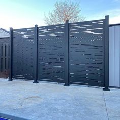 a black metal fence is next to a building