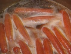 hot dogs are being cooked in a pot