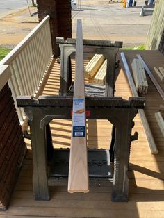 a wooden bench sitting on top of a porch