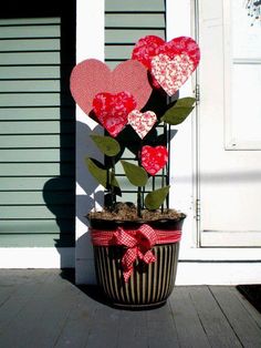 a potted plant with paper hearts on it